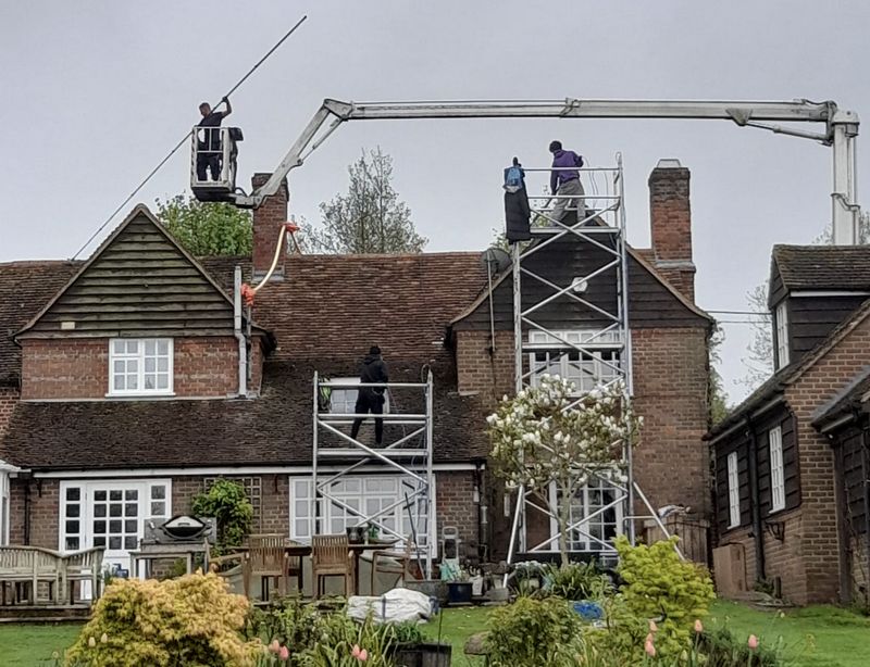 The Moss Cleaners using cherry picker and scaffolding to clean roof safely and professionally in London, 5 Midcroft, Ruislip HA4 8ET, UK